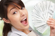 Closeup of a happy young woman holding currency notes