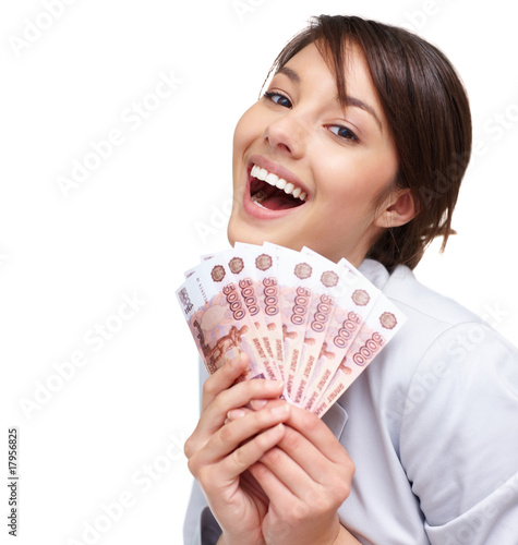 Photo: Cute female smiling with fan of currency notes on white Cute female smiling with fan of currency notes on white