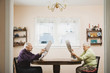 Senior couple reading newspapers