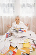 Senior woman looking at pile of bills
