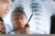 Asian doctors having discussion over xray print