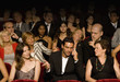 Hispanic man talking on cell phone in theatre