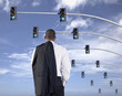 African businessman standing under traffic lights
