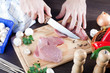 Person slicing fresh raw pork meat