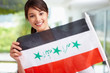 Pretty young female displaying an Iraqi flag