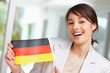 Photo: Beautiful young woman with a German flag Beautiful young woman with a German flag