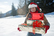 Young woman with Christmas presents in winter scene