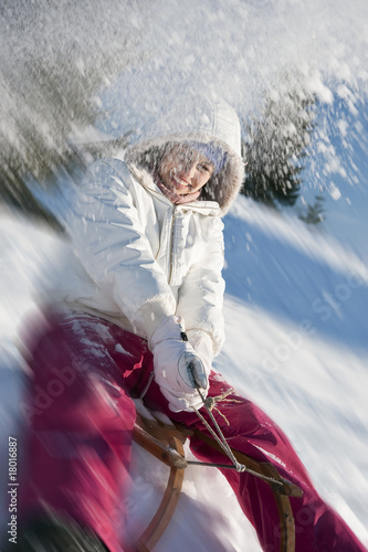 Photo: Young woman sledding Young woman sledding