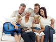 Happy family playing guitar at home