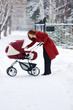 young mother with baby carriage