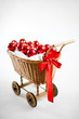 christmas cart with baubles and red bow on white background christmas cart with baubles and red bow on white background
