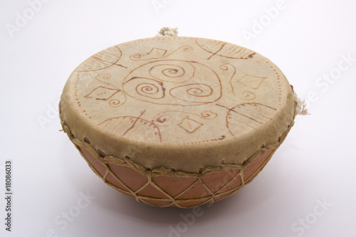 Photo: Traditional drum with shamanic signs on a white background. Traditional drum with shamanic signs on a white background.
