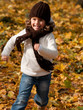 Happy girl running in autumn park