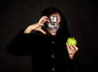 Two-faced witch with green apple grining