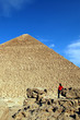 Woman in red in front of world famous Egyptian pyramids