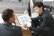 Businesspeople discussing charts Businesspeople discussing charts