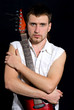 Portrait of young trendy man holding electric guitar - isolated