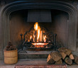 Stone fireplace with a lit roaring fire Stone fireplace with a lit roaring fire