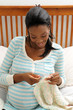 Pregnant woman knitting
