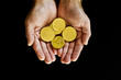 Gold coins in hand