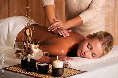 Photo: professional masseur doing massage of female back professional masseur doing massage of female back