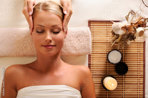 Photo: attractive female getting recreation massage of head attractive female getting recreation massage of head