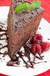 Slice of delicious chocolate cake with raspberries and mint
