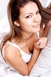 woman lying in bedroom smiling