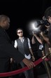 Male celebrity arriving at media event