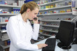 pharmacist using computer and telephone pharmacist using computer and telephone