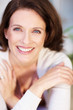 Closeup portrait of a lovely woman with hands crossed