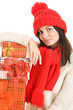 Pretty young woman with three gifts