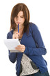 Young woman doing records by pen in notepad
