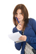 Young woman doing records by pen in notepad