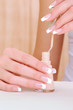 Macro shot of female hands with bottle enamel Macro shot of female hands with bottle enamel