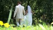 Bride and Groom Walking in Flowers