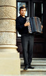 Male playing on the accordion against a grunge background