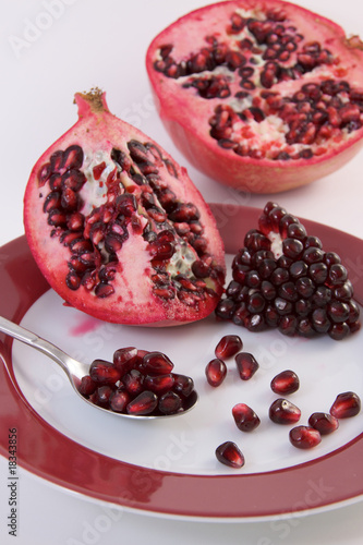Photo: pomegranate nice decorated on a plate pomegranate nice decorated on a plate