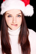 Girl biting her lip wearing Santa hat