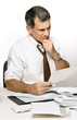 Confused Man Reading a Bill or Bank Statement