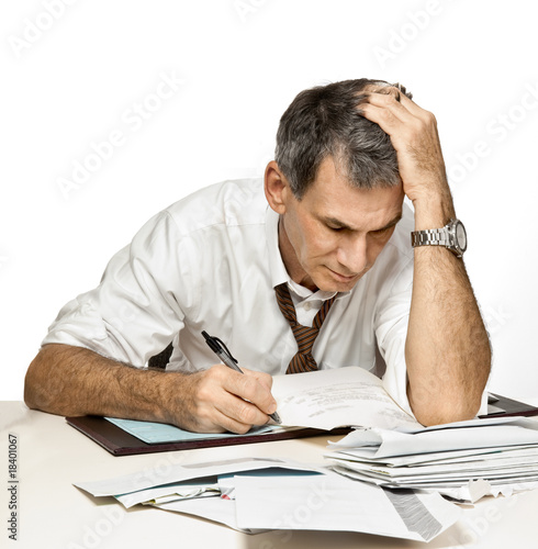 Photo: Man Paying Bills and Worrying Man Paying Bills and Worrying