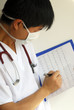 A doctor reviews the patient’s EKG chart