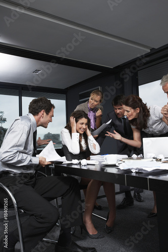 Photo: Business people screaming on a girl Business people screaming on a girl