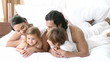 Video: Happy young family lying in bed Happy young family lying in bed