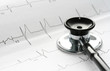 Close-up of stethoscope and EKG waveform as a background