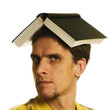 man with open book on head on white background