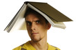 man with open book on head on white background