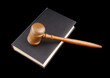 Judge's gavel legal book isolated on black