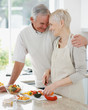 Happy couple preparing a meal together at home Happy couple preparing a meal together at home
