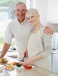 Smiling senior couple preparing food in the kitchen Smiling senior couple preparing food in the kitchen